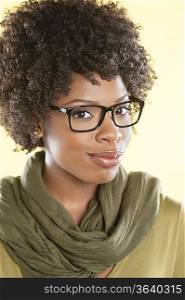 Portrait of an African American woman wearing glasses with a stole round her neck over colored background