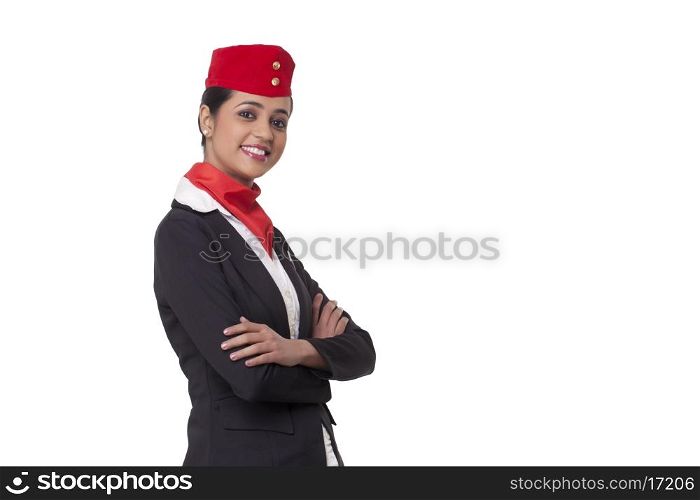 Portrait of an air hostess with arms crossed standing against white background