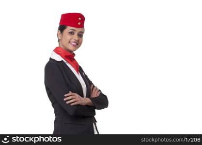 Portrait of an air hostess with arms crossed standing against white background