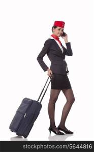 Portrait of an airhostess on call while holding luggage bag&rsquo;s handle isolated over white background