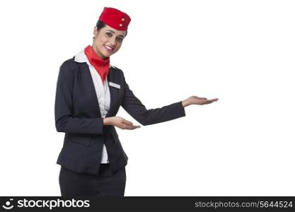 Portrait of an airhostess welcoming against white background