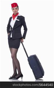 Portrait of an airhostess with luggage bag isolated over white background