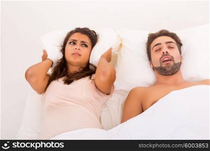 Portrait of an annoyed woman awaken by her fiance&rsquo;s snoring