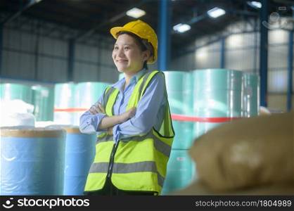 Portrait of An Asian smiling engineering woman is working in modern warehouse