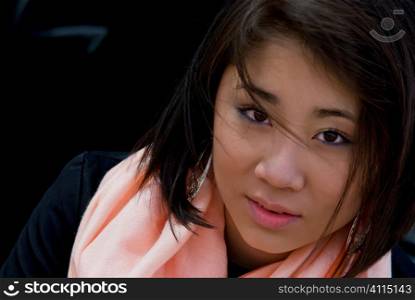Portrait of an Asian woman in a peach scarf