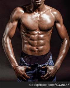 Portrait of an athletic black man on black background