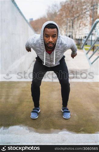 Portrait of an athletic man doing some exercise outdoors. Sport, fitness and healthy lifestyle.