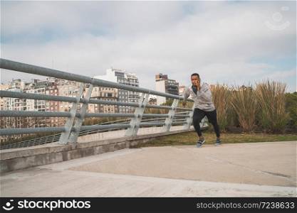 Portrait of an athletic man running outdoors in the street. Sport, fitness and healthy lifestyle.