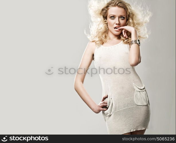 Portrait of an attractive blond lady with a curly coiffure