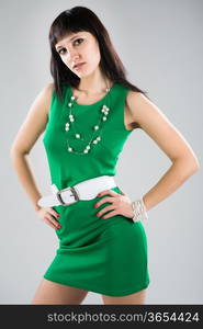 Portrait of an attractive brunette in a green dress