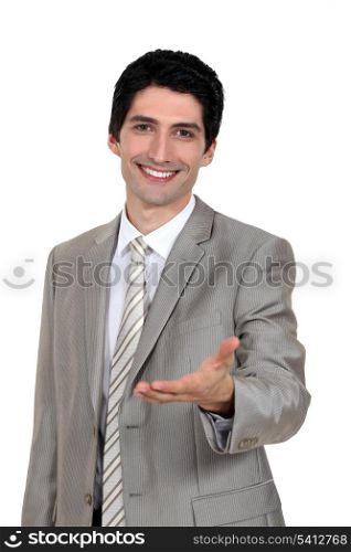 Portrait of an attractive businessman holding out his hand