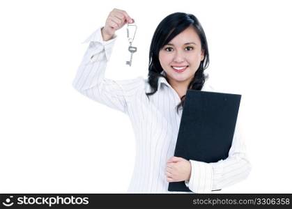 Portrait of an attractive businesswoman holding clipboard and key over white background.