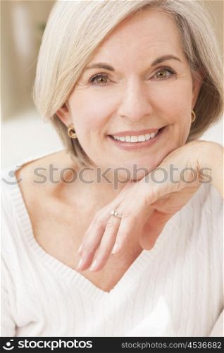 Portrait of an attractive elegant senior woman relaxing at home.