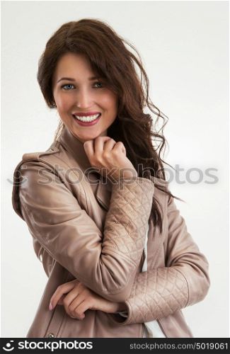 Portrait of an attractive fashionable young brunette woman thinking with hand on chin