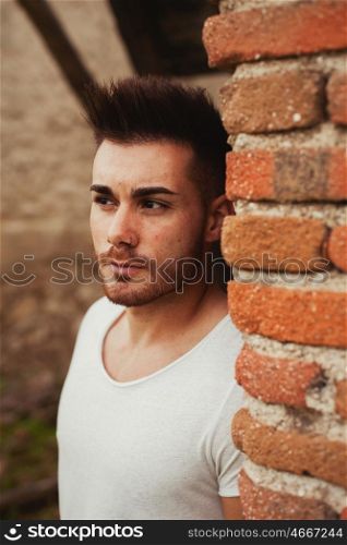 Portrait of an attractive guy in a old house