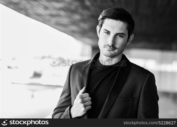 Portrait of an attractive man, model of fashion, wearing modern suit.