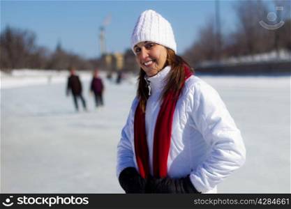Portrait of an attractive woman on a skating rink during winter