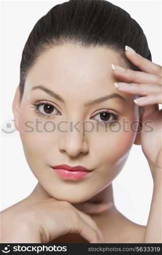 Portrait of an attractive woman touching her face