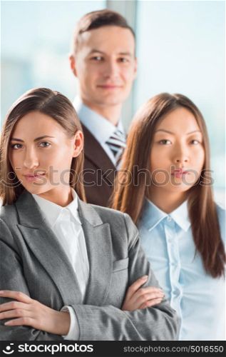Portrait of an attractive young business group standing together at office