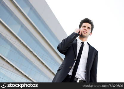 Portrait of an attractive young businessman on the phone in an office building