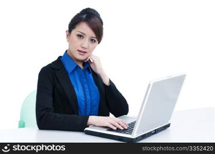 Portrait of an attractive young businesswoman using laptop over white background
