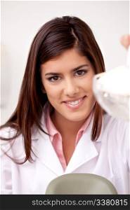 Portrait of an attractive young woman dentist looking at the camera