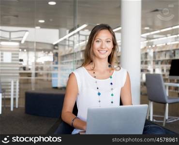 Portrait of an attractive young woman using her laptop