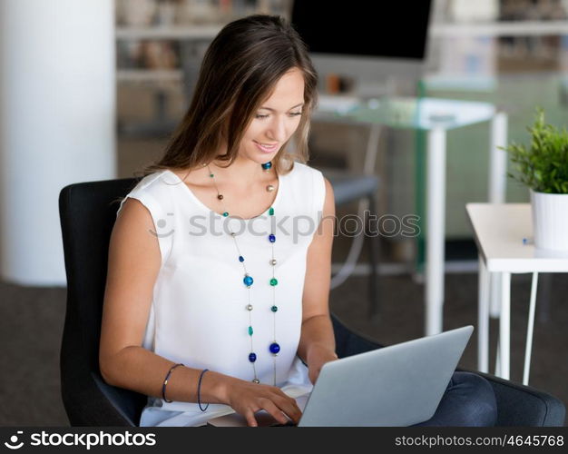 Portrait of an attractive young woman using her laptop