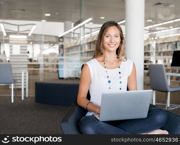 Portrait of an attractive young woman using her laptop