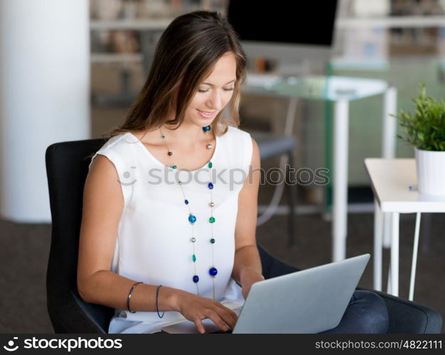 Portrait of an attractive young woman using her laptop