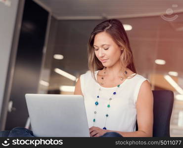 Portrait of an attractive young woman using her laptop