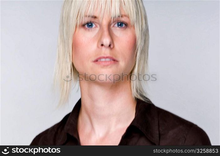 Portrait of an edgy blonde woman with movement in eyes.