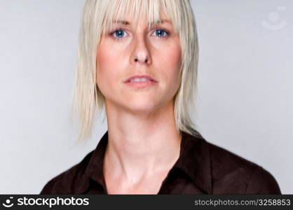 Portrait of an edgy blonde woman with movement in eyes.