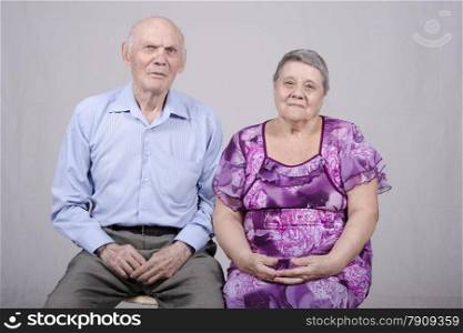 Portrait of an elderly couple eighty years. Studio light background