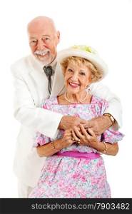 Portrait of an elderly couple with the husband embracing his beautiful wife. Isolated on white.
