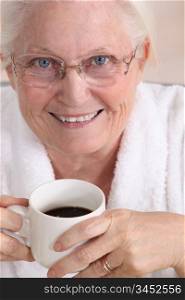 Portrait of an elderly woman drinking coffee