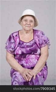 Portrait of an elderly woman of eighty years. Studio light background