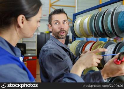 portrait of an electrician working with wire