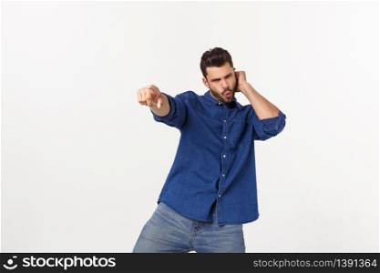 Portrait of an emotional young man dancing. Isolated over white background.. Portrait of an emotional young man dancing. Isolated over white background