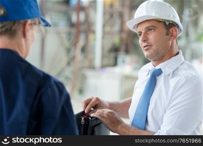 portrait of an engineer talking to colleague