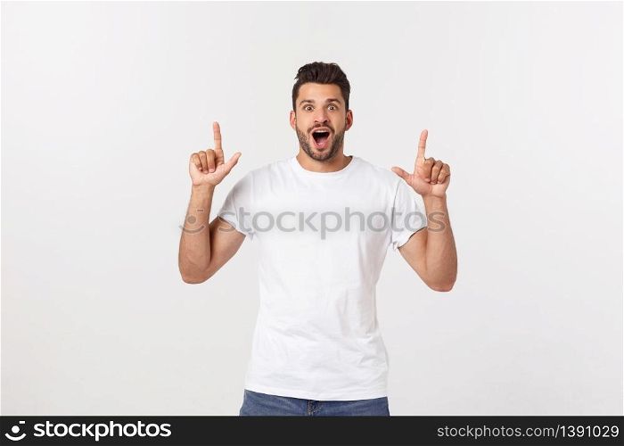 Portrait of an excited happy man pointing finger away at copy space. Isolated on yellow background. Portrait of an excited happy man pointing finger away at copy space. Isolated on yellow background.