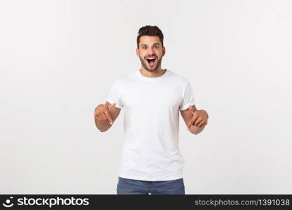 Portrait of an excited happy man pointing finger away at copy space. Isolated on yellow background. Portrait of an excited happy man pointing finger away at copy space. Isolated on yellow background.