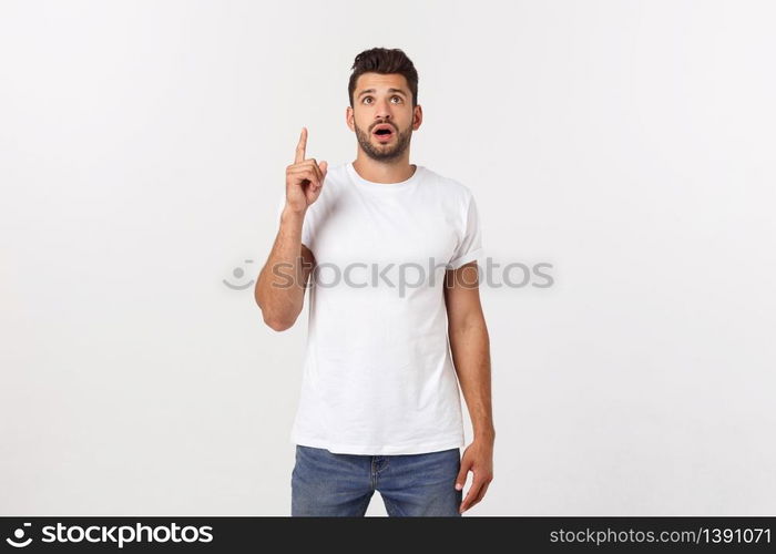 Portrait of an excited happy man pointing finger away at copy space. Isolated on yellow background. Portrait of an excited happy man pointing finger away at copy space. Isolated on yellow background.