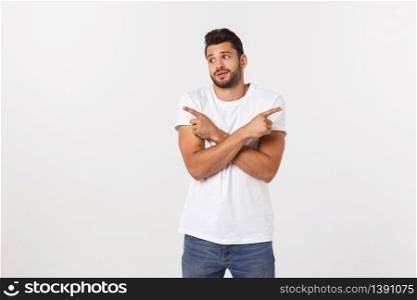 Portrait of an excited happy man pointing finger away at copy space. Isolated on yellow background. Portrait of an excited happy man pointing finger away at copy space. Isolated on yellow background.