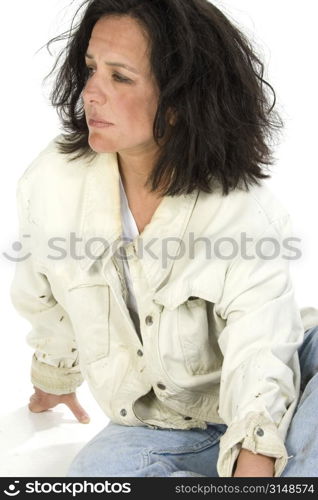 Portrait of an impoverished woman over white. Torn stained clothes. Dirt on hair and face. Shot in studio.