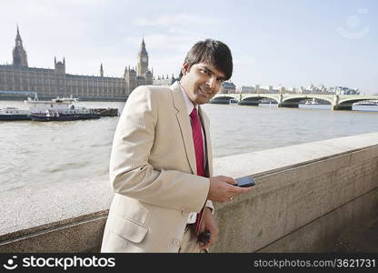 Portrait of an Indian businessman text messaging