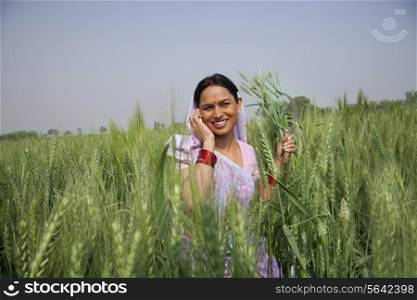Portrait of an Indian female farm worker talking on phone