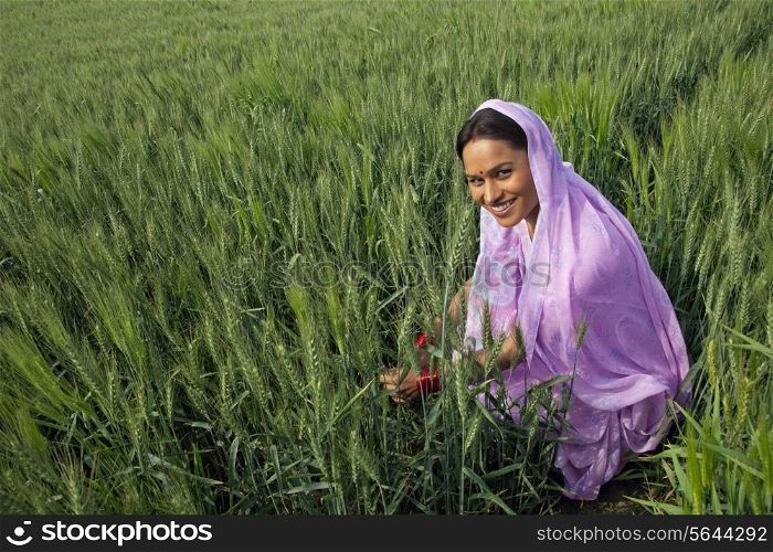 Portrait of an Indian female farm worker working in the field