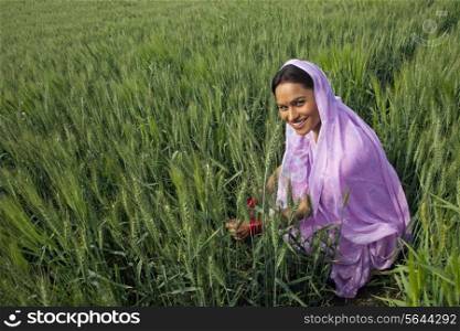 Portrait of an Indian female farm worker working in the field