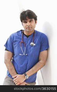 Portrait of an Indian male doctor leaning over white background